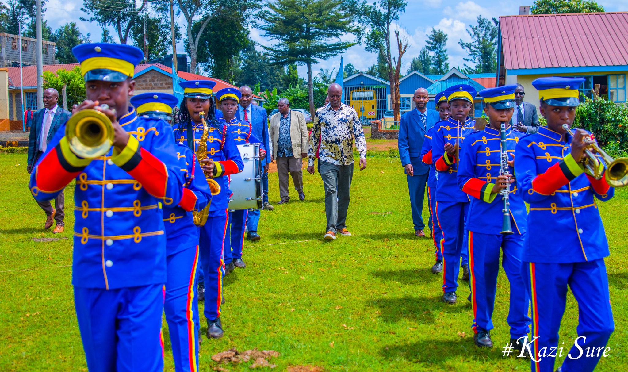 MP and Principal entering stadium led by band